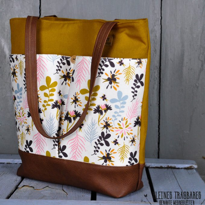 personalized women's bag in brown and green tones with a floral pattern in the middle