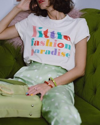 Ana Bacinger sits on the green couch and wears an organic t shirt from LFP collection