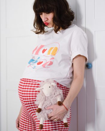 Pregnant Ana Bacinger wears Mon Bébé 2022 T-shirt from her LFP collection and holds a toy in her hand