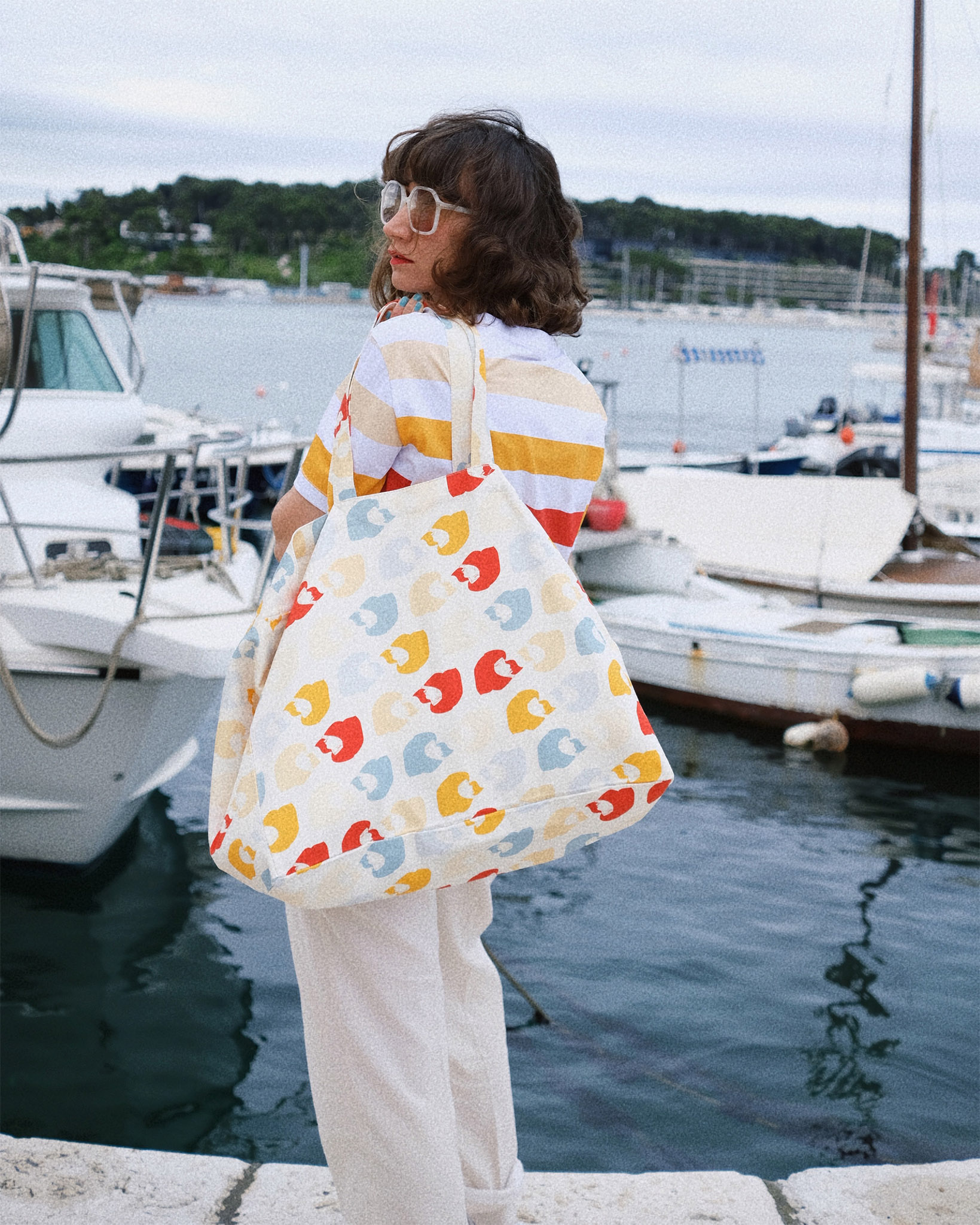 girl with big summer colourful personalized bag from LFP collection on the sea
