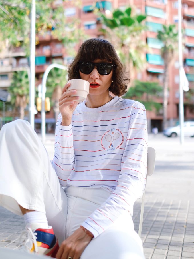 Ana Bacinger sits and drink coffee and wears T-shirt with retro stripes from her LFP collection